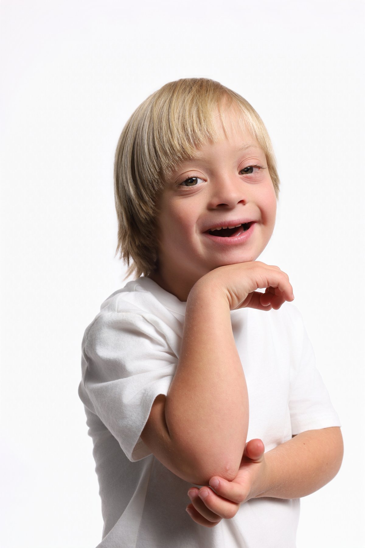 Wesley Wyatt smiling in a white tee, chin resting on his hand