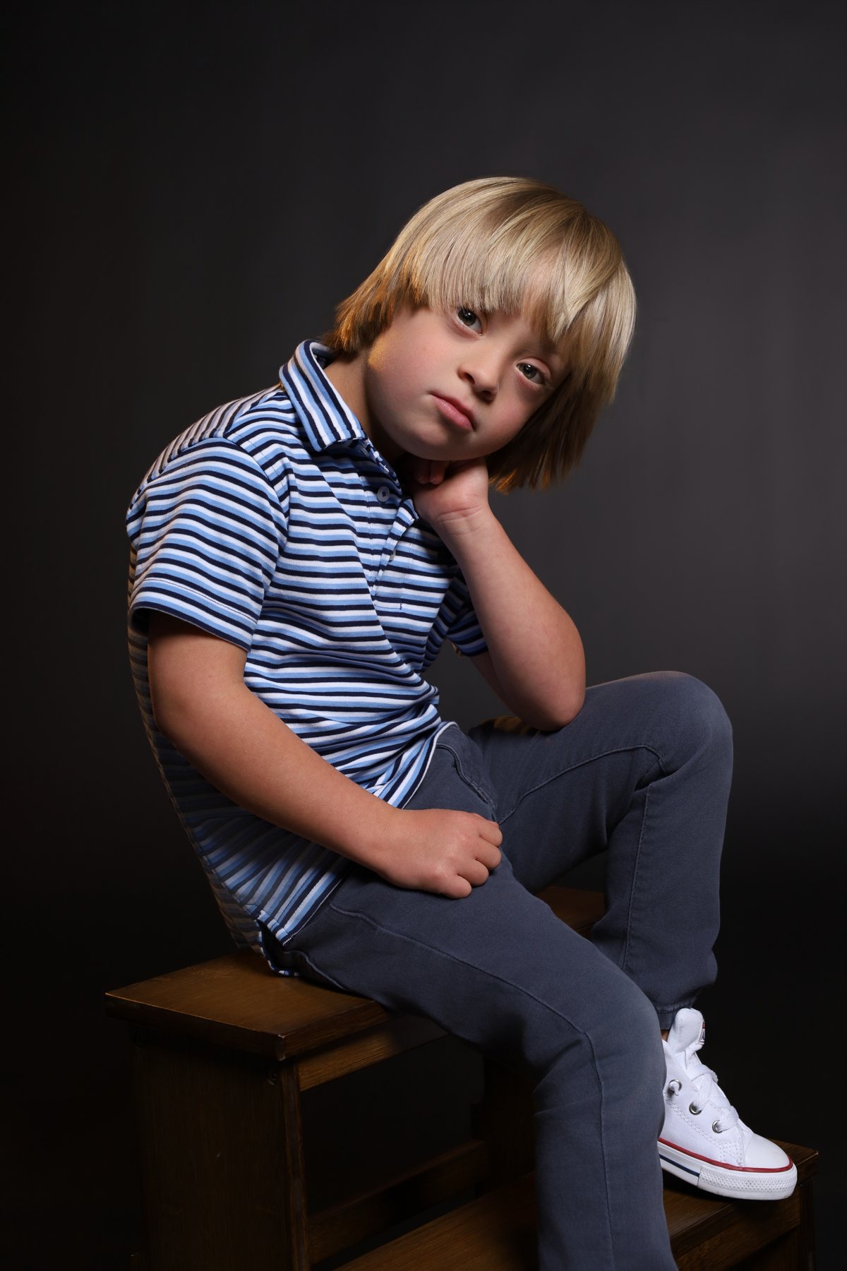 Wesley Wyatt seated on a wooden crate, head resting on his hand