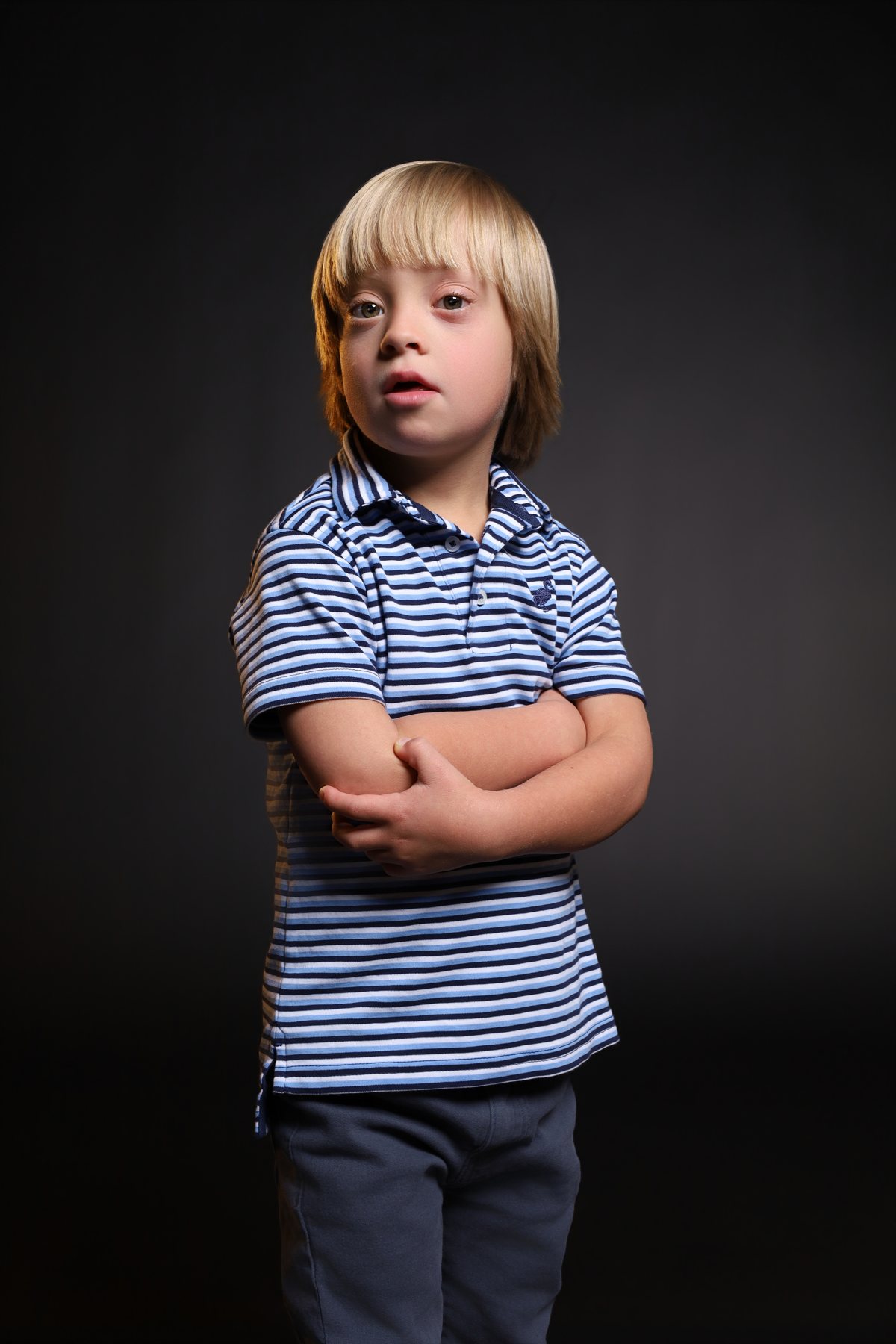 Wesley Wyatt in a striped polo with arms crossed